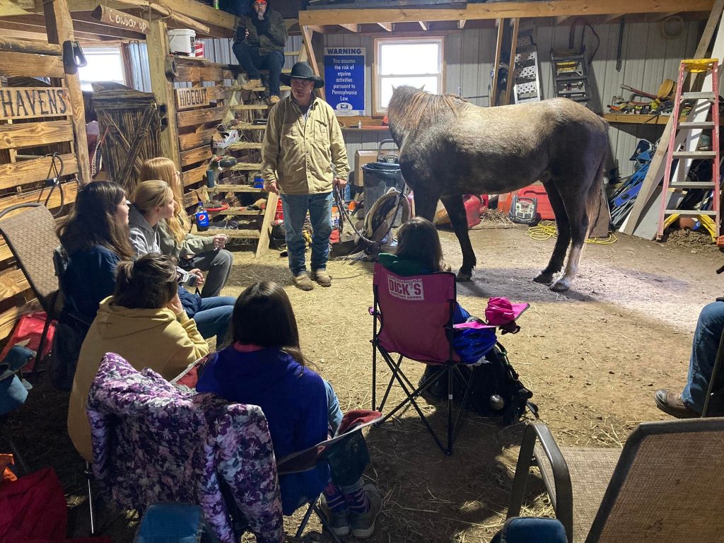 Girls in a stable with horses